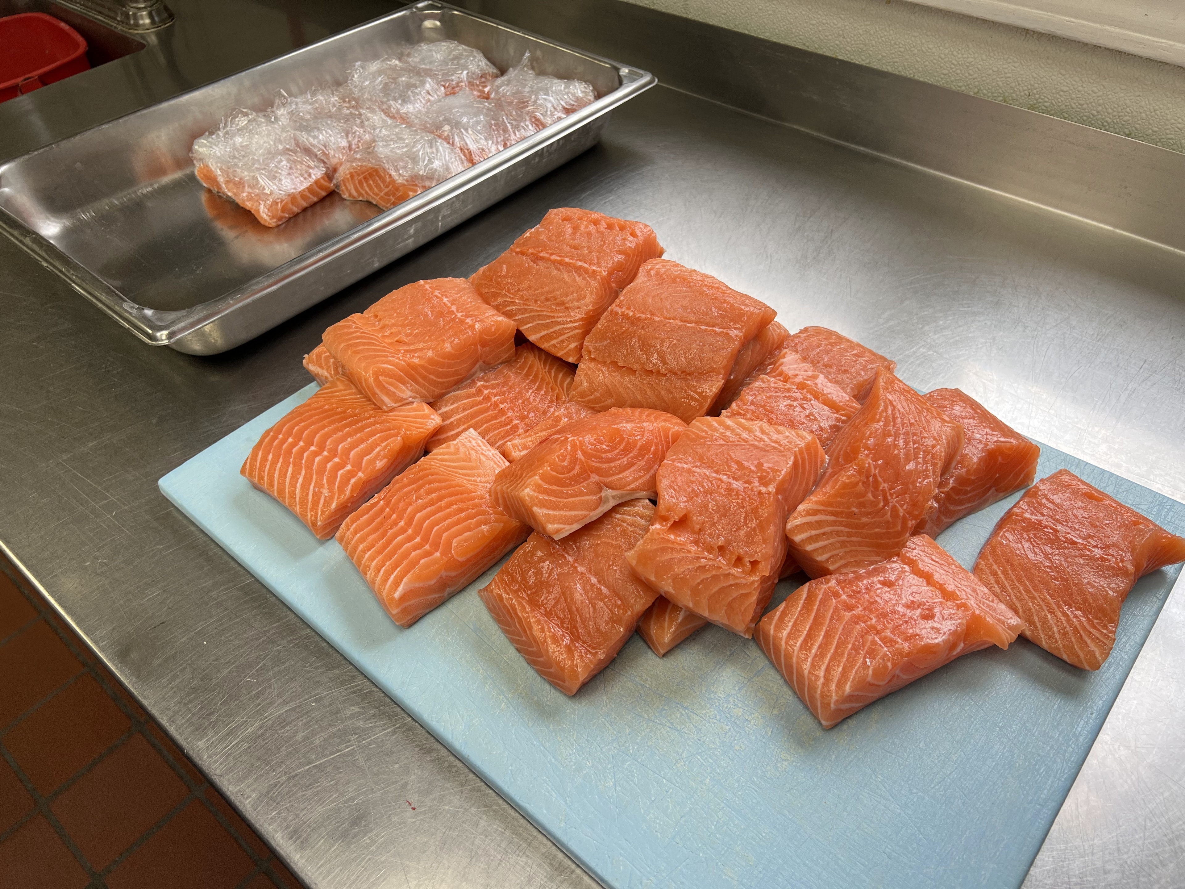 Fresh salmon being cut and prepared in the kitchen at D'Agostino's Navajo Bar & Grille, Bridgman, Michigan