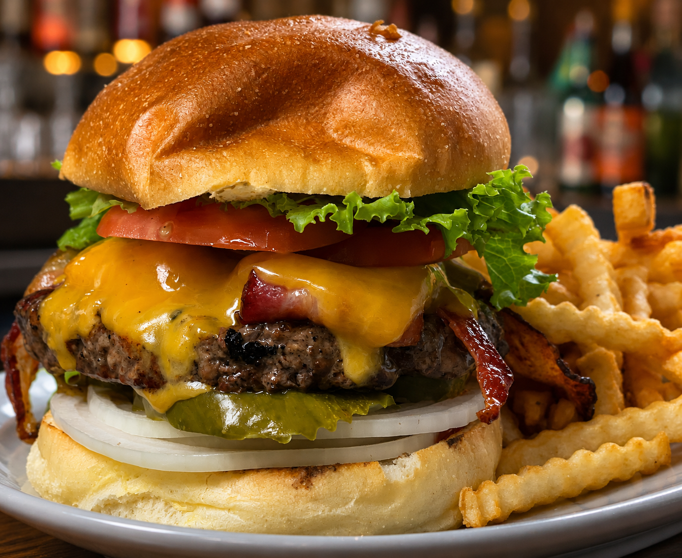 Angus burger with cheddar, bacon, and crinkle fries — D'Agostino's Navajo Bar & Grille, Bridgman, Michigan